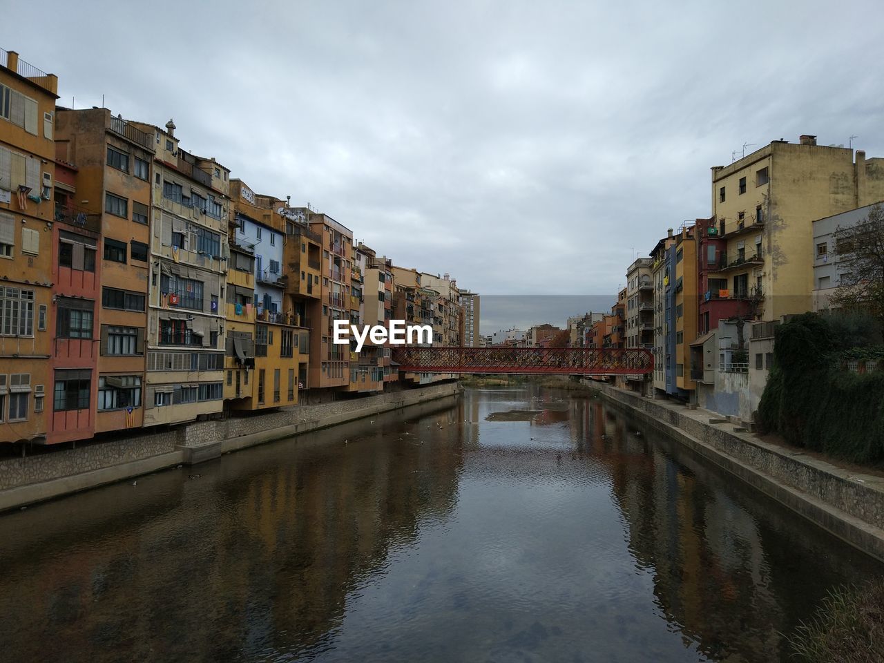 Reflection of buildings in water against sky