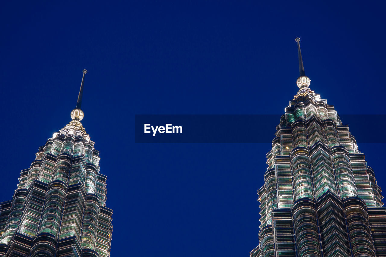 LOW ANGLE VIEW OF BUILDING AGAINST BLUE SKY