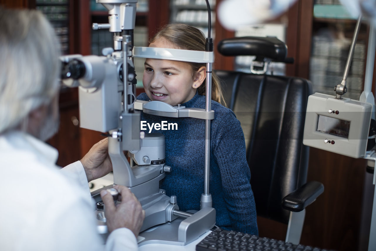 Girl doing eye test at the optometrist