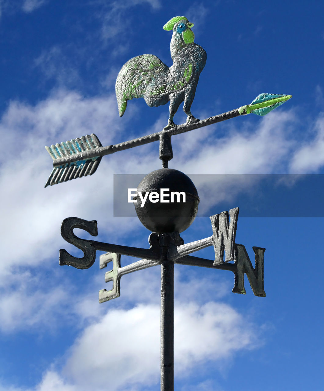 Weather vane to indicate the wind direction with blue sky with clouds