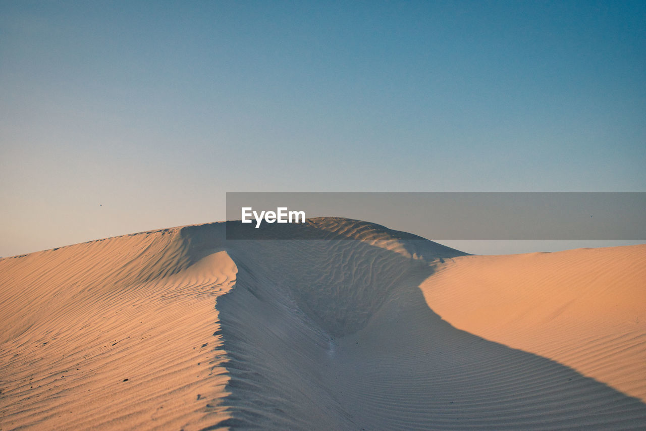 Scenic view of desert against clear sky