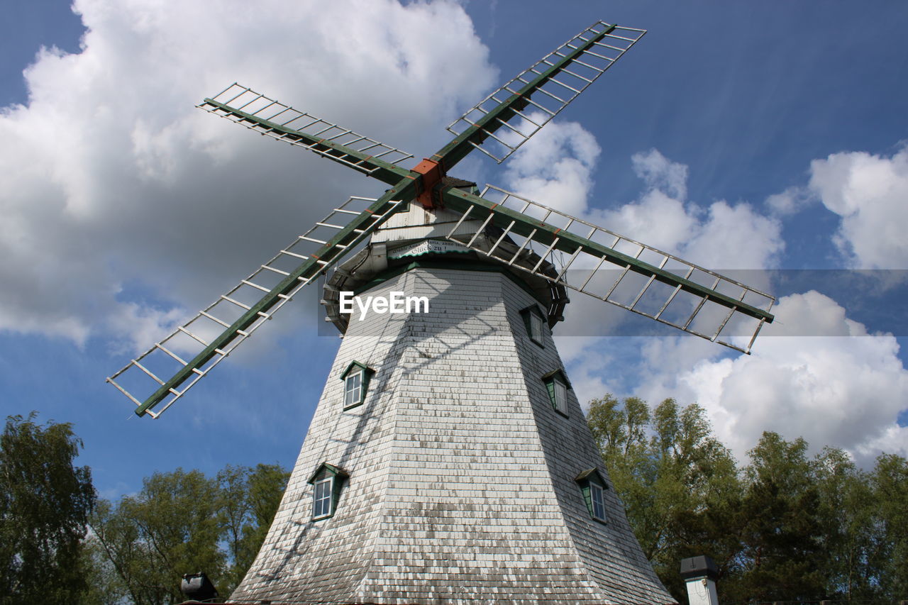 Low angle view of traditional windmill against sky