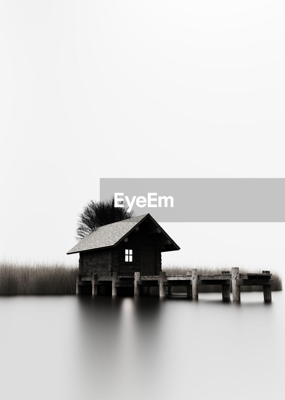 BUILT STRUCTURE BY HOUSE AGAINST SKY