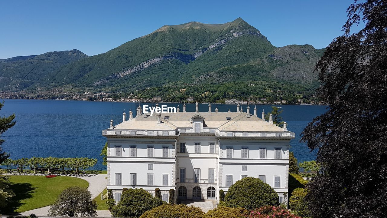 Scenic view of sea and building against clear sky