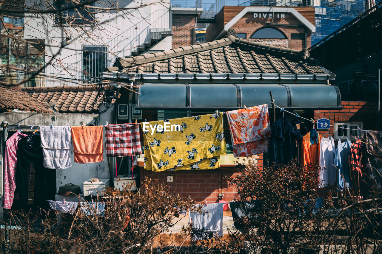 Clothes drying against buildings in city