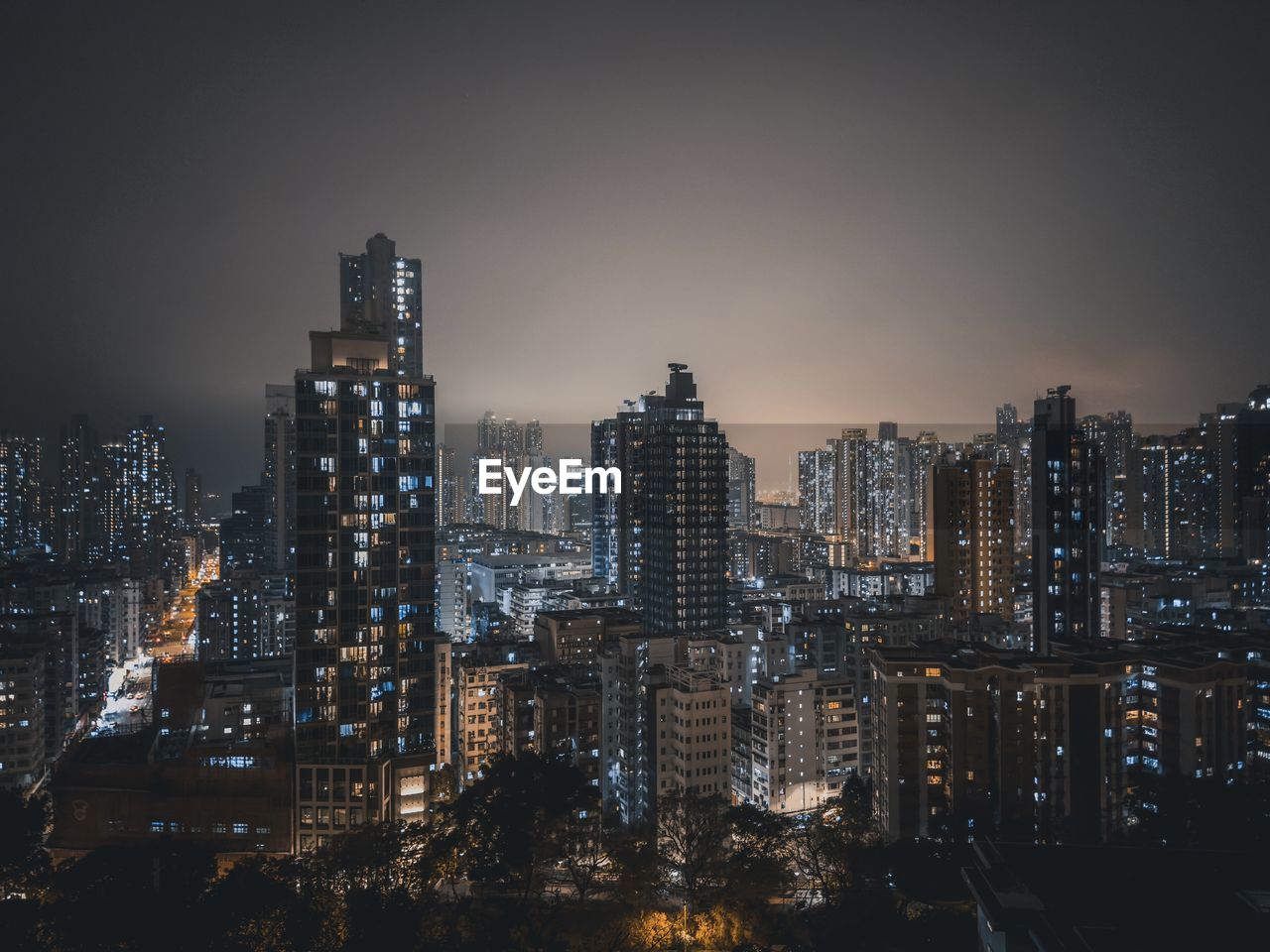 Illuminated cityscape against sky at night