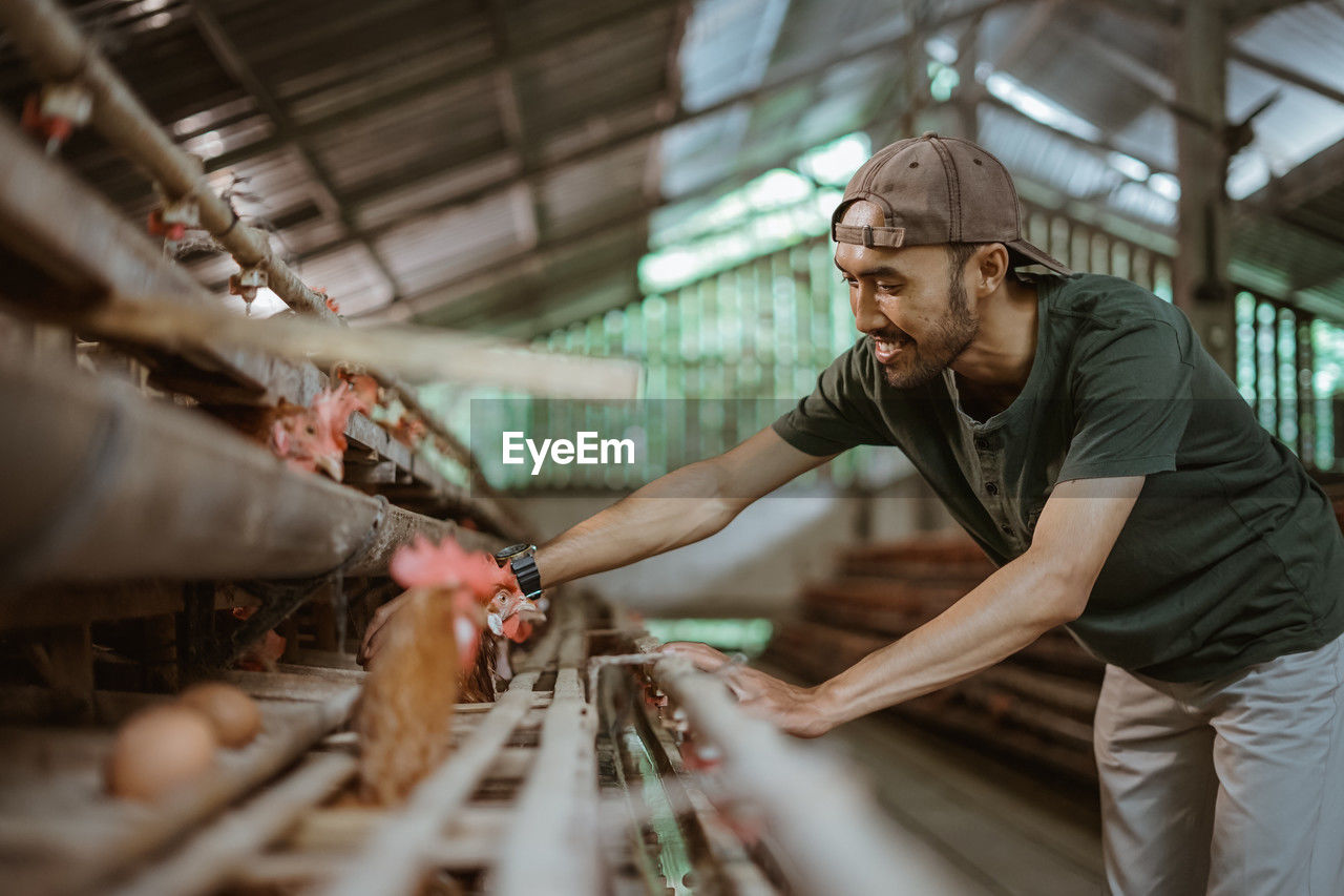 portrait of young man working at market stall