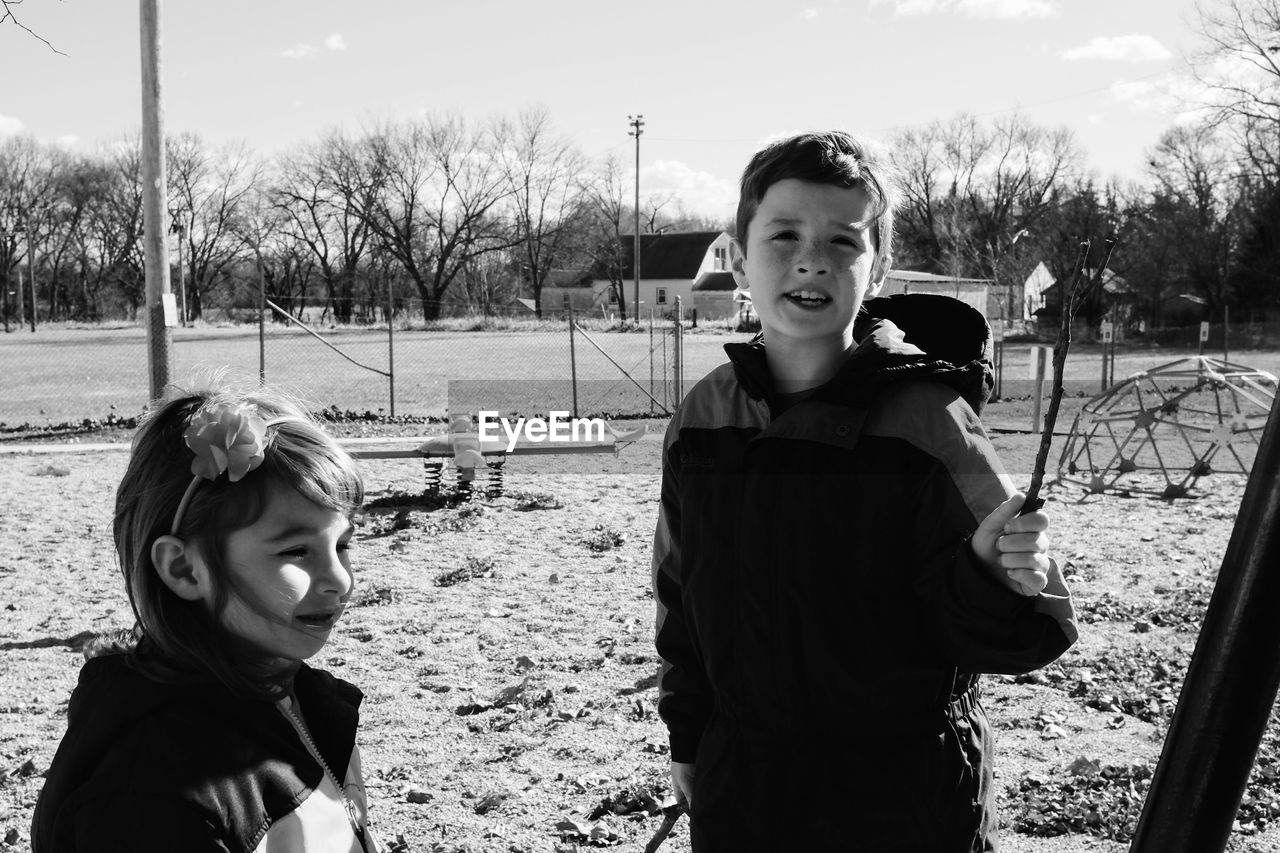 Siblings standing in playground