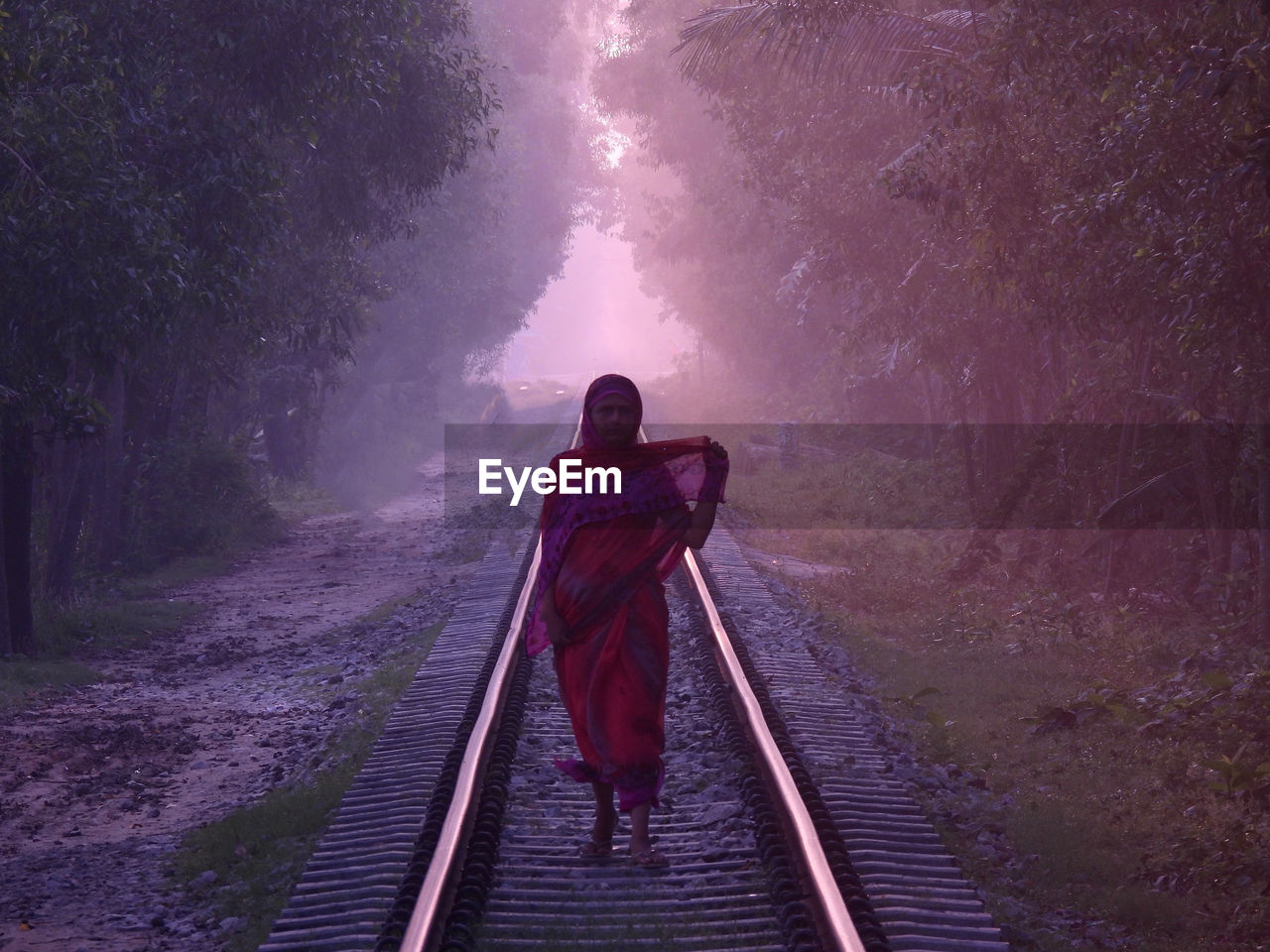 Woman standing on railroad track