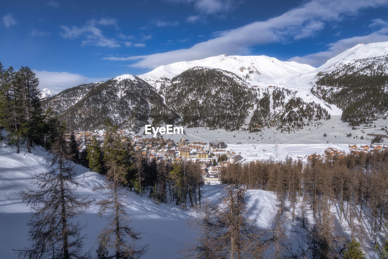 snow, cold temperature, winter, mountain, scenics - nature, tree, beauty in nature, environment, sky, wilderness, snowcapped mountain, plant, mountain range, landscape, nature, pine tree, pinaceae, coniferous tree, cloud, pine woodland, forest, land, ridge, no people, tranquility, tranquil scene, travel, travel destinations, water, frozen, tourism, non-urban scene, day, outdoors, mountain peak, white, ice, blue, woodland