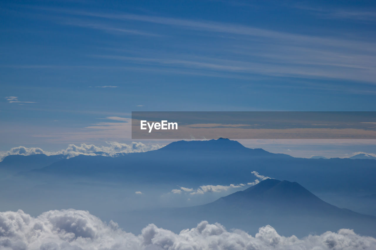 Scenic view of cloudscape and mountains against sky