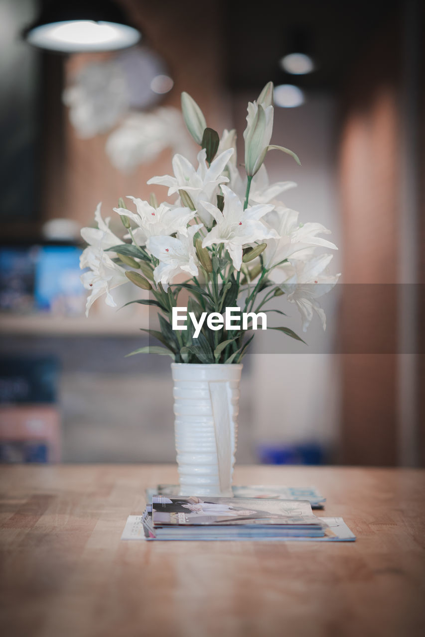 Close-up of white flower vase on table at home