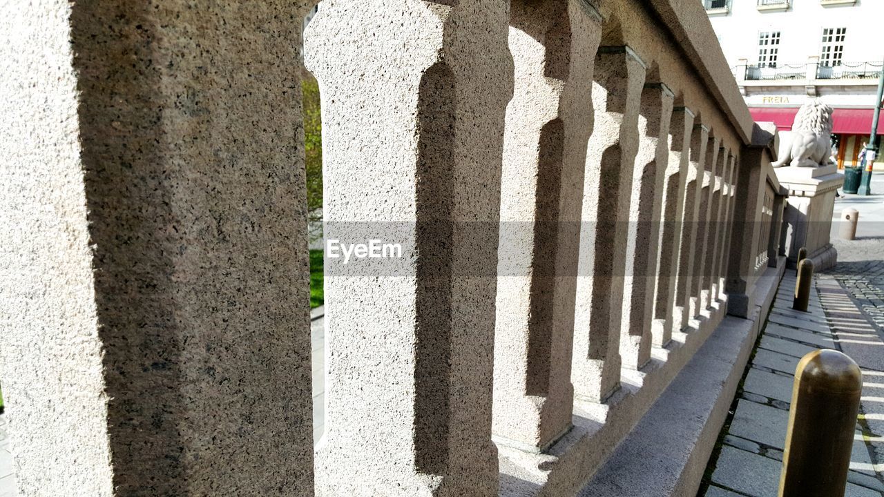 Close-up of concrete balustrade on railing in city