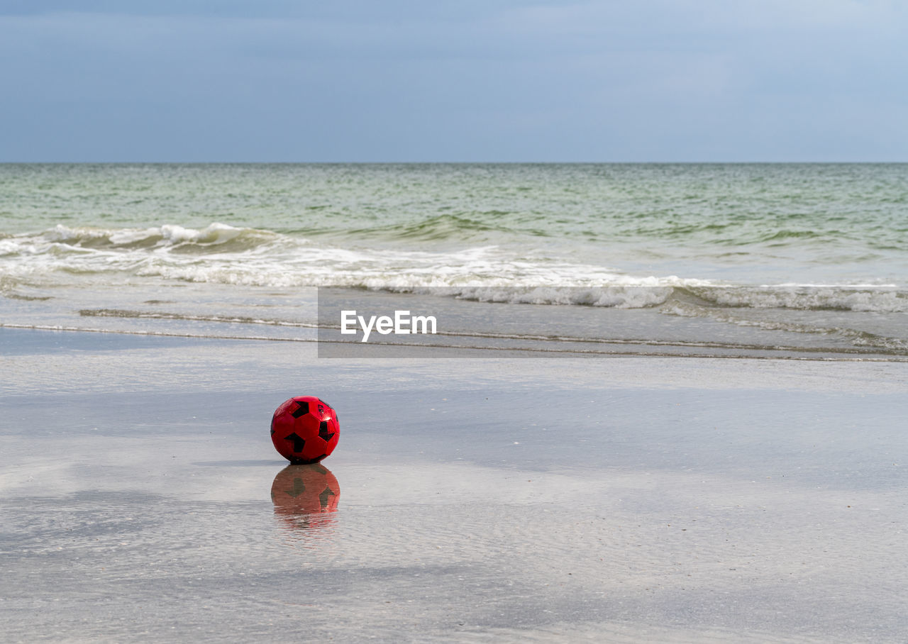 Quiet place,  red ball on the beach