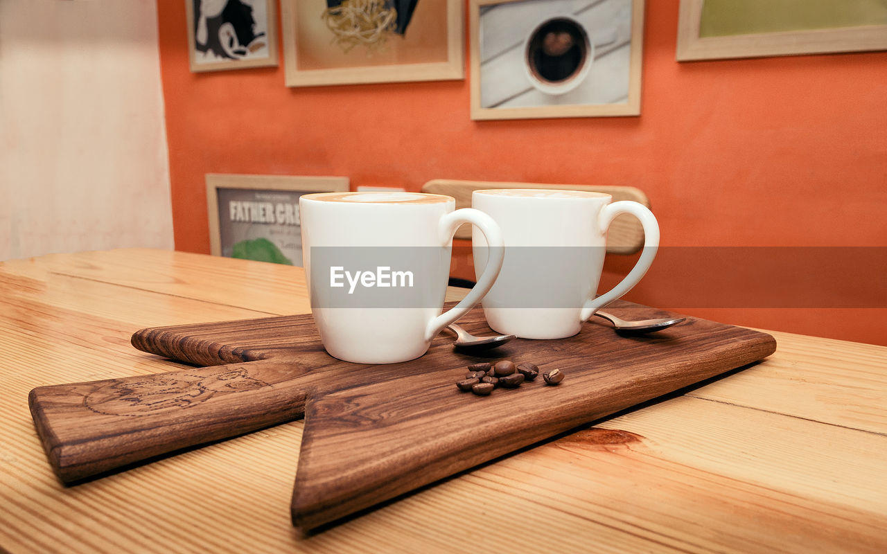 CLOSE-UP OF CUP ON TABLE