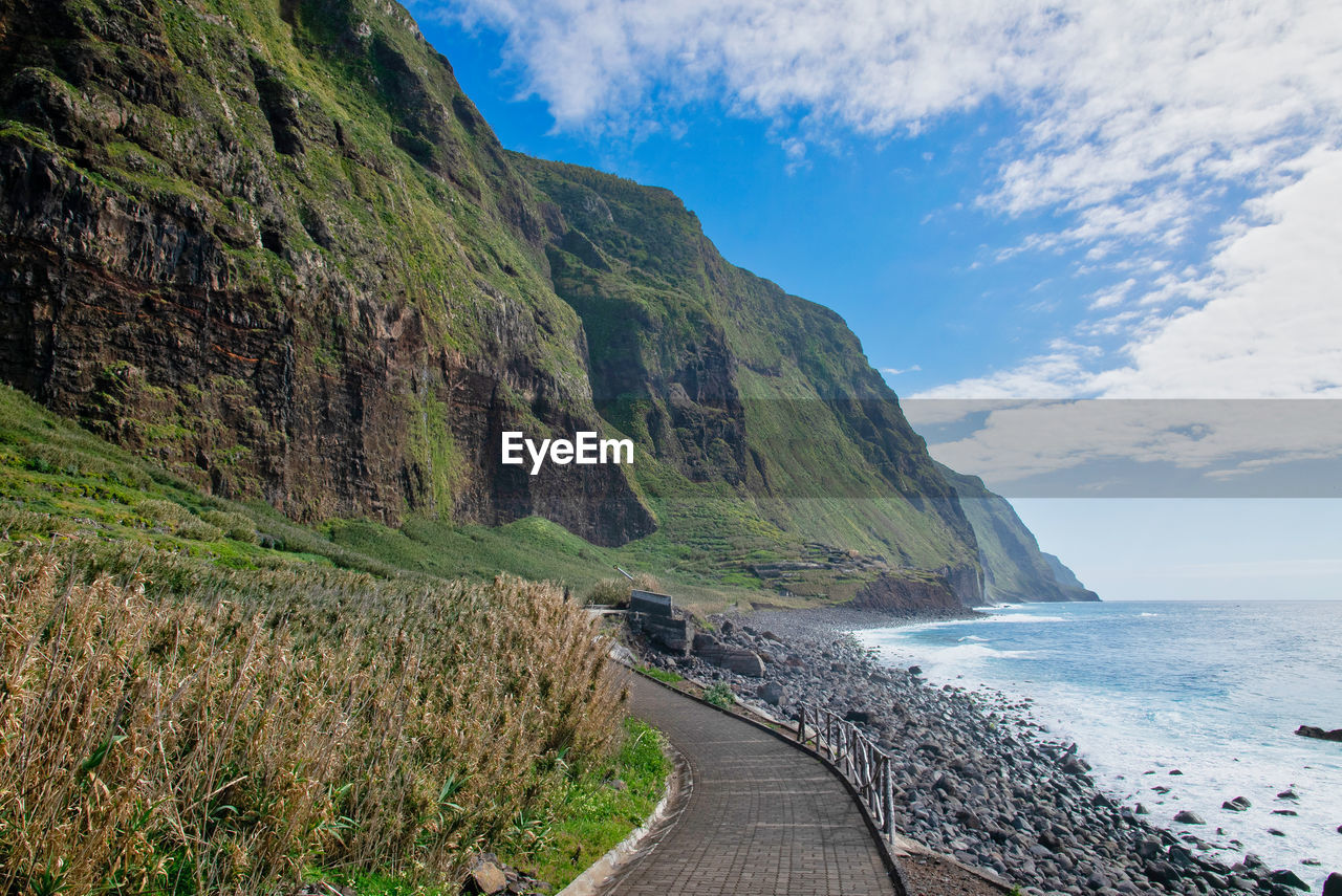 Panoramic view of road by sea against sky