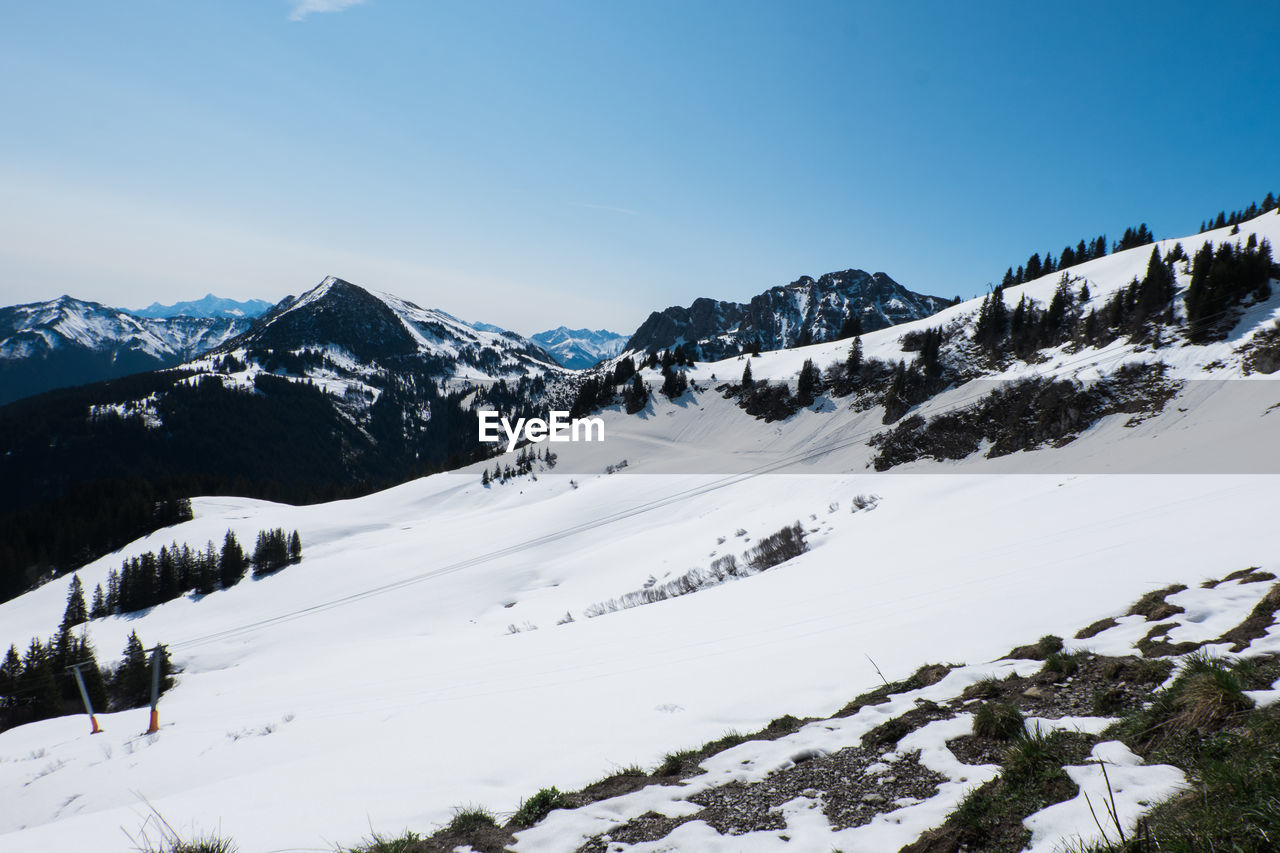 Scenic view of snow mountains against clear sky