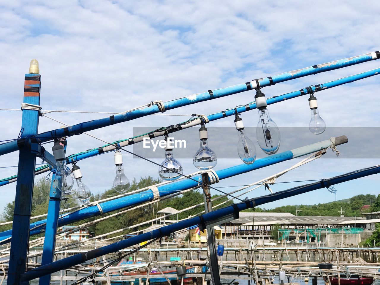 LOW ANGLE VIEW OF CABLES HANGING AGAINST SKY