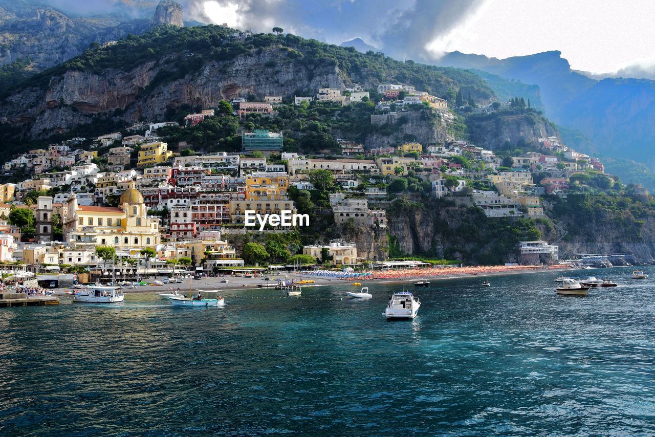 Buildings at amalfi coast against mountain