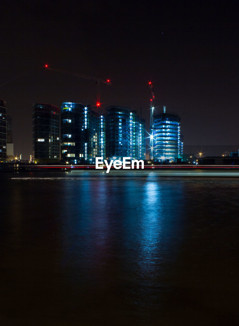 ILLUMINATED SKYSCRAPERS AT NIGHT