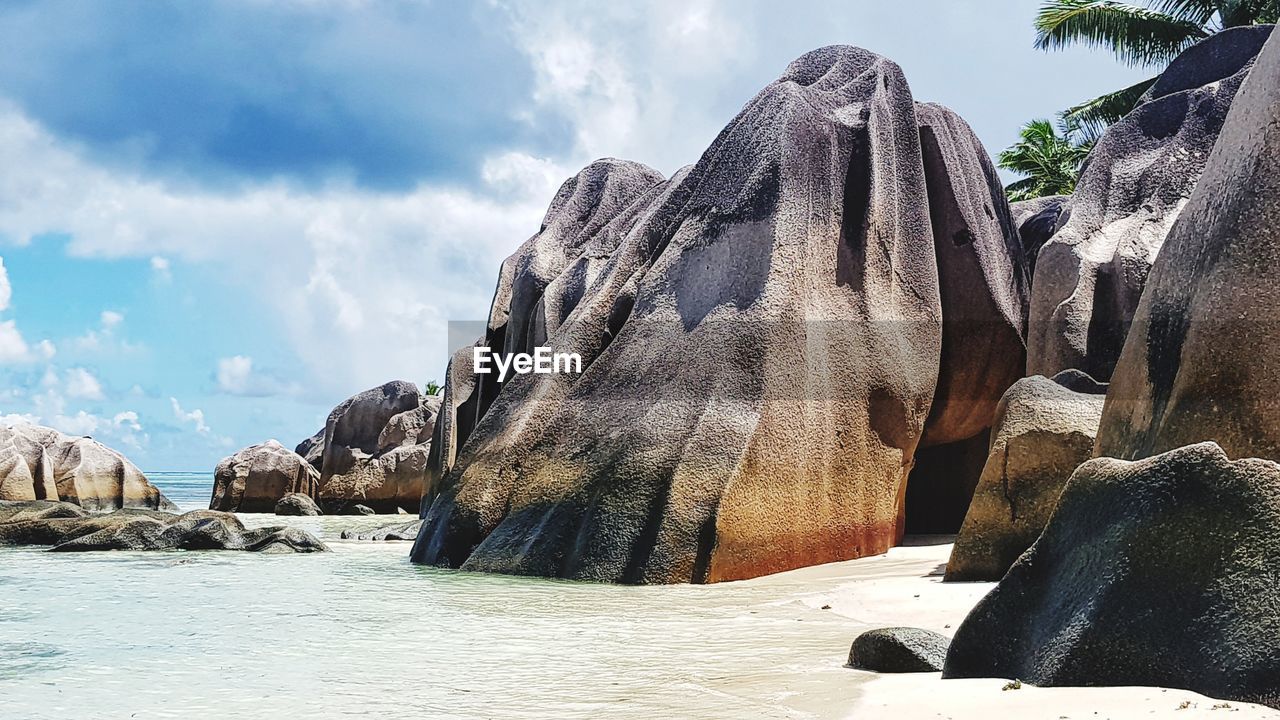 Panoramic view of rocks on beach against sky