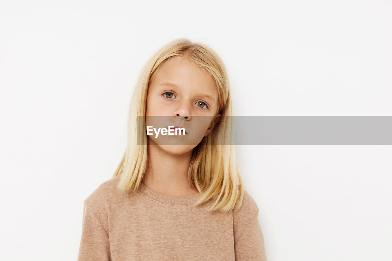 portrait of smiling young woman against white background