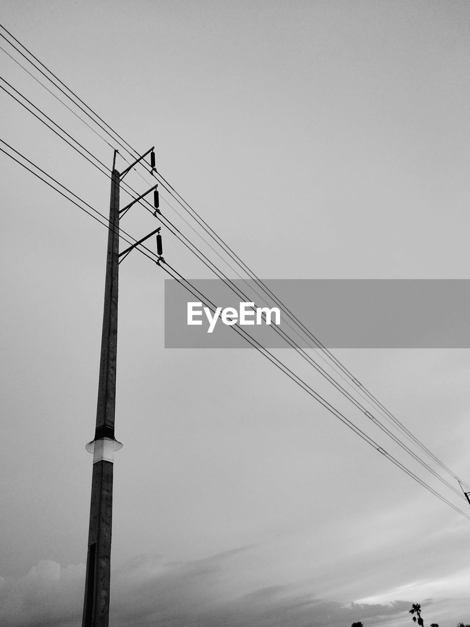 Low angle view of telephone pole against sky