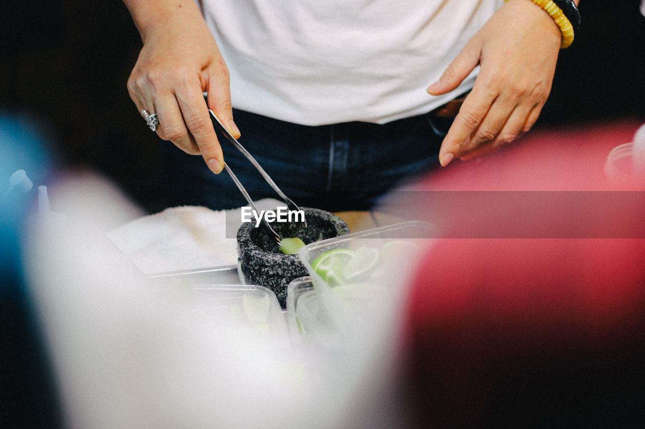 Midsection of person preparing food on table