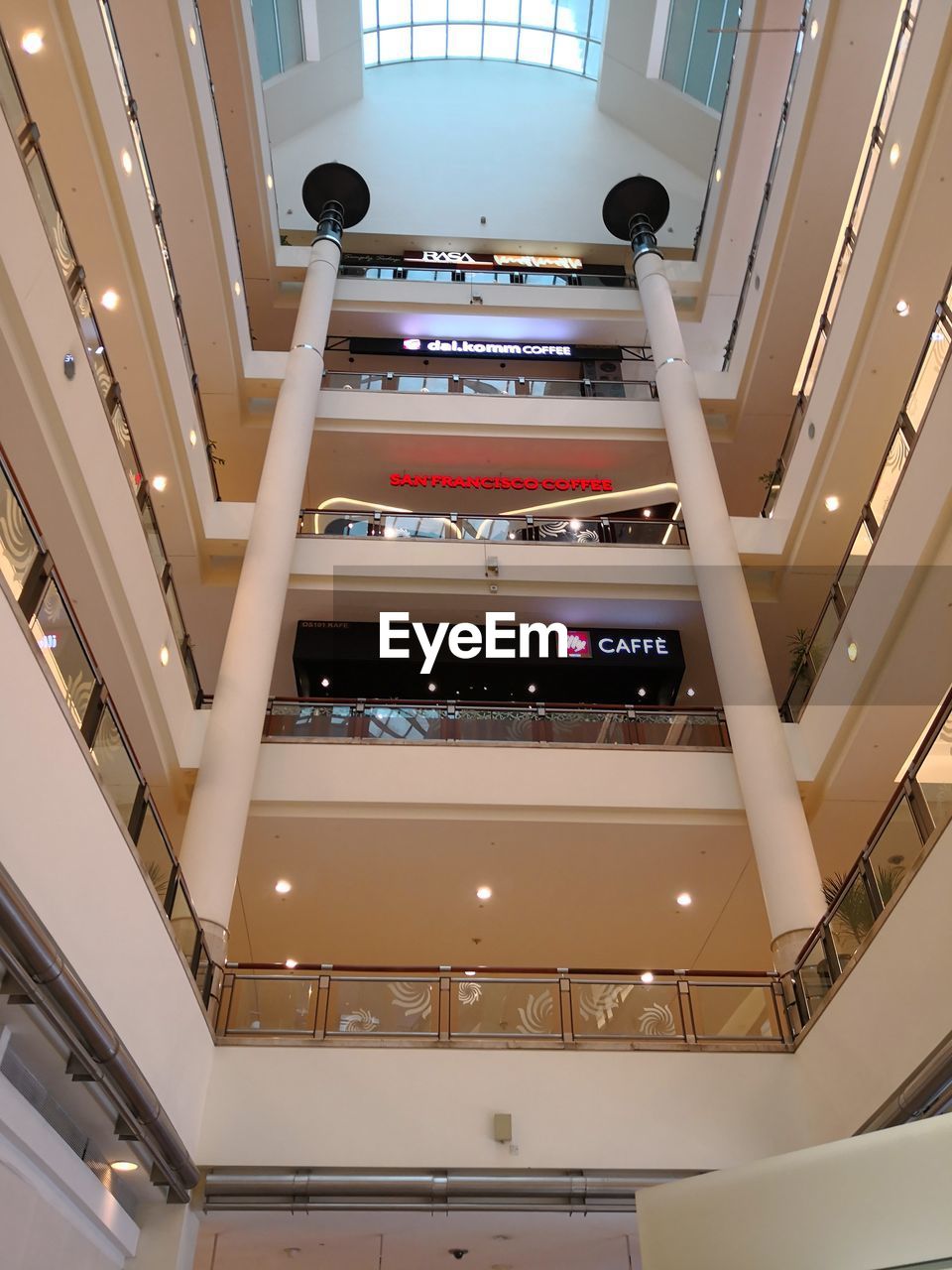 LOW ANGLE VIEW OF ILLUMINATED SKYLIGHT IN BUILDING