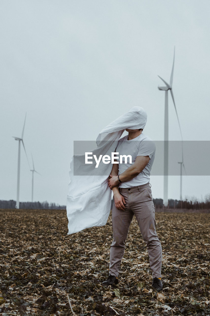 Man covered face wind turbines