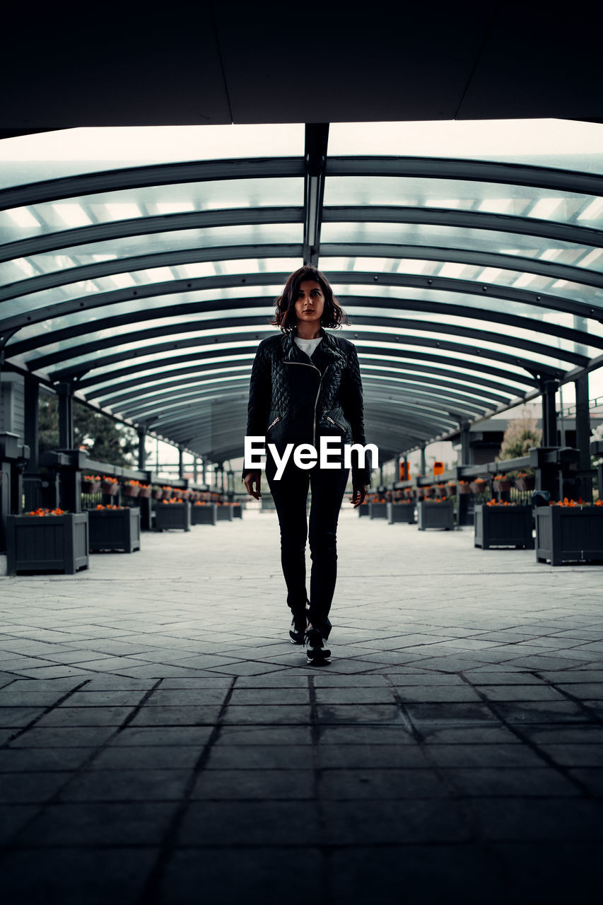 Portrait of woman standing on railroad station platform