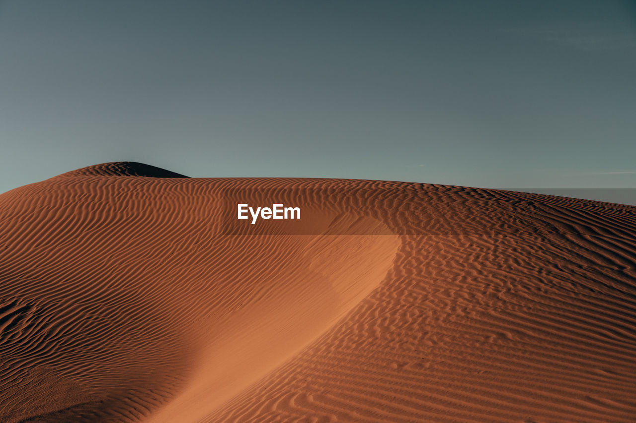 low angle view of desert against clear sky