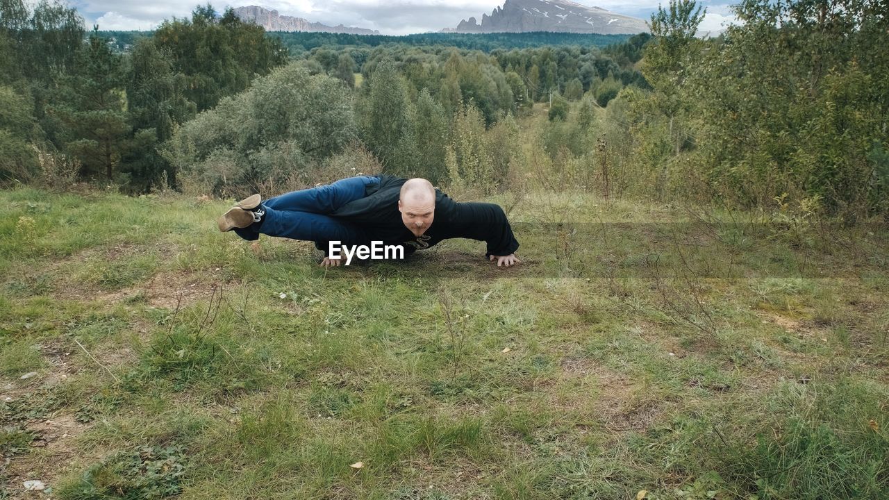 MAN LYING ON LAND