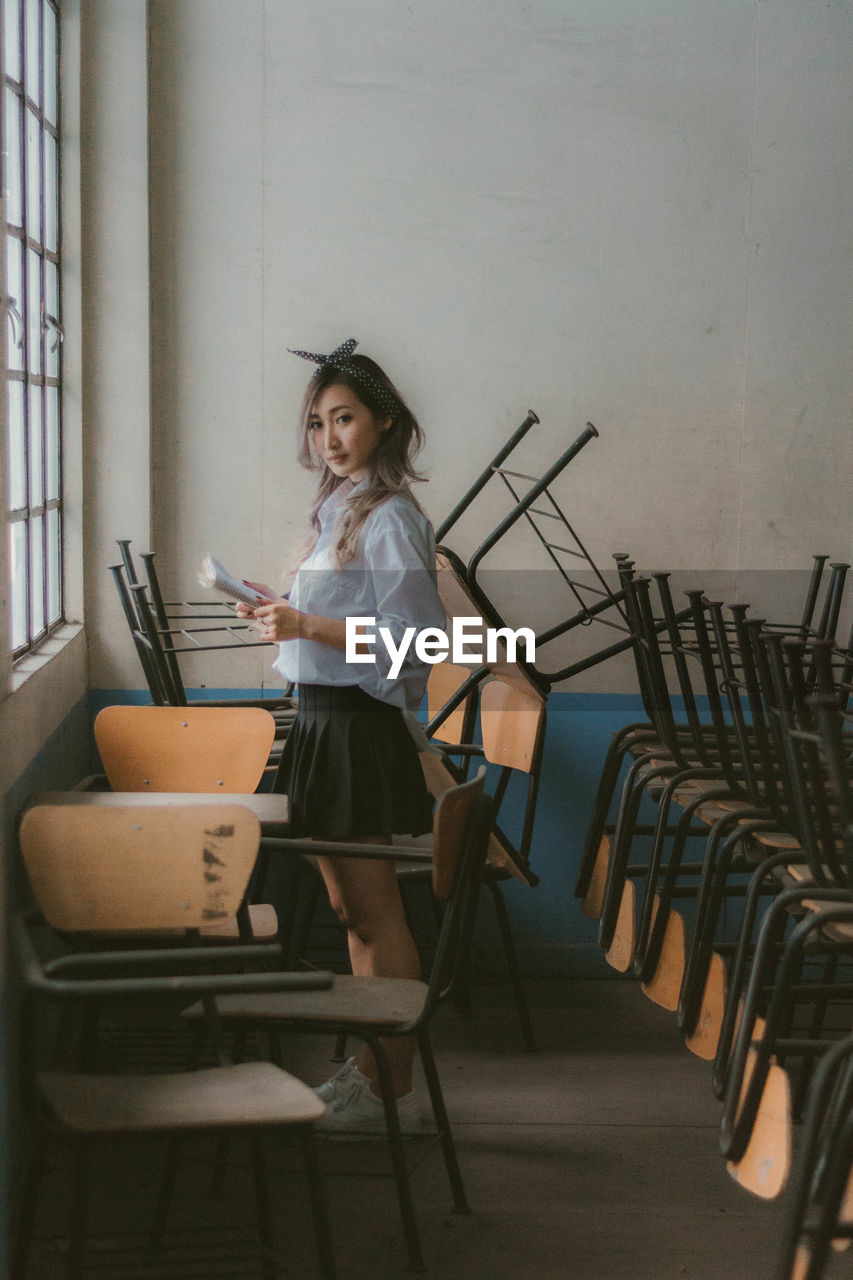 Side view of portrait of woman at classroom