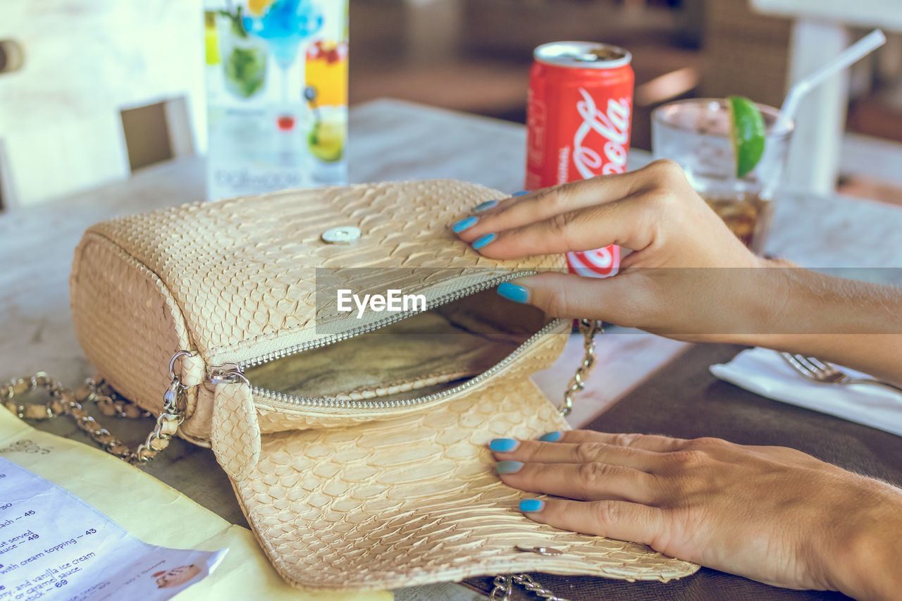 MIDSECTION OF WOMAN HOLDING BASKET WITH WICKER