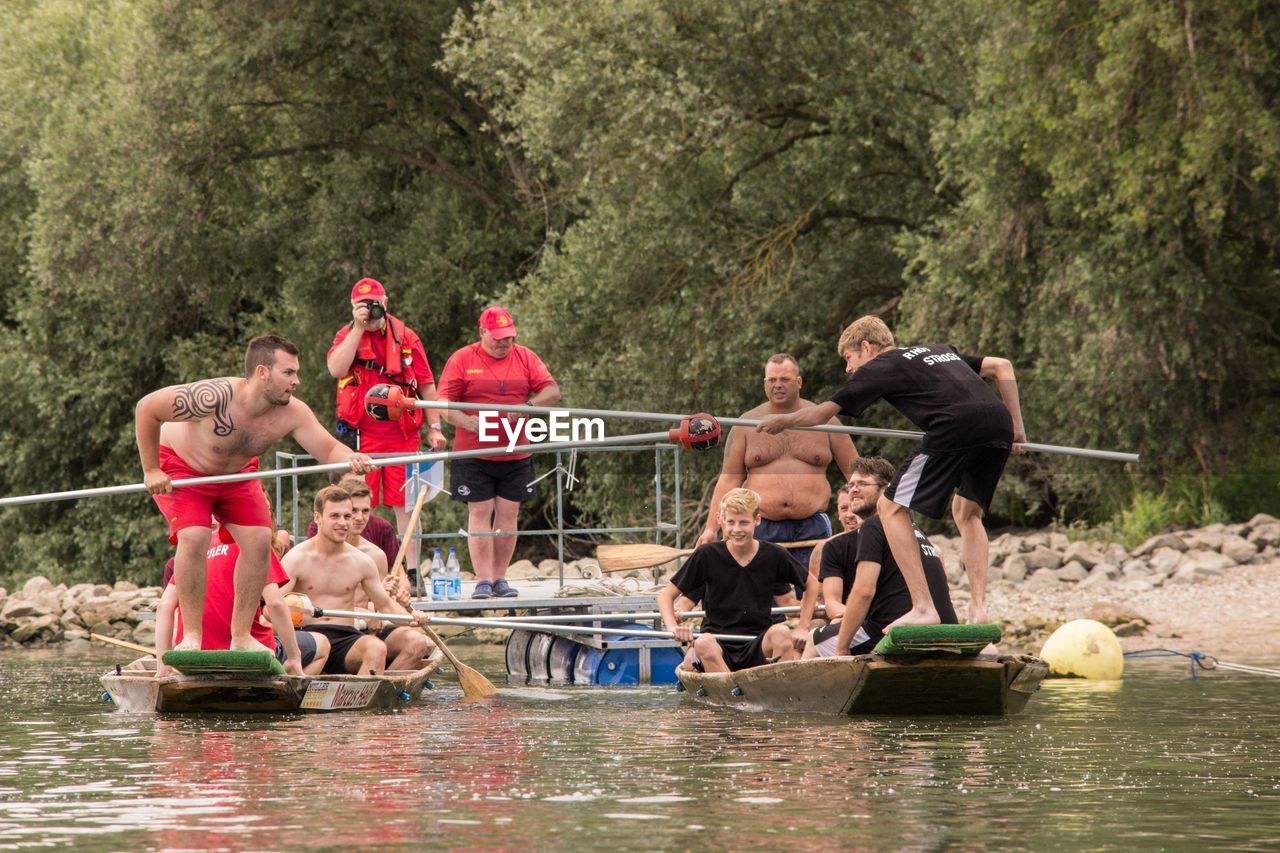 PEOPLE SITTING ON RIVERBANK