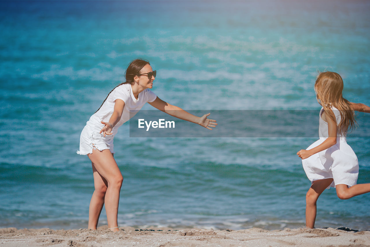 side view of young woman standing at beach