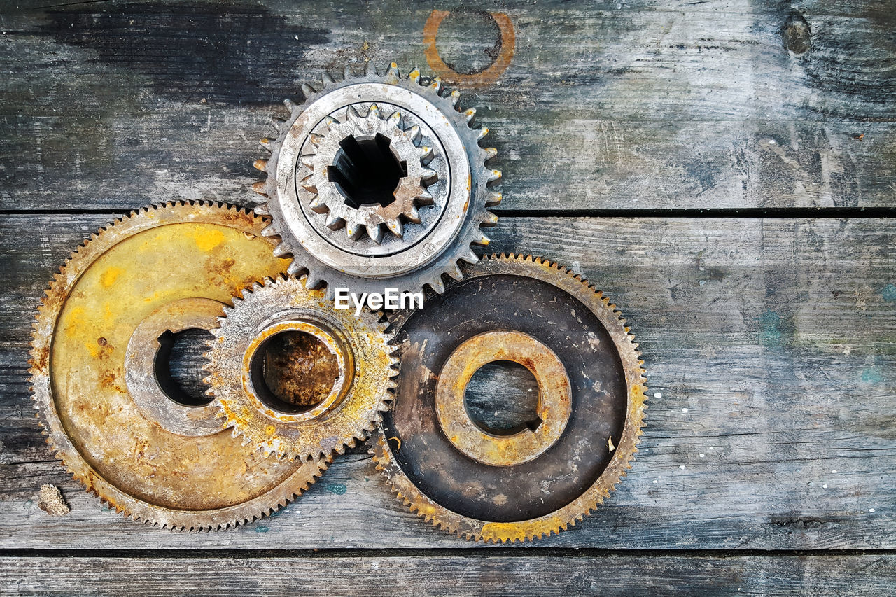 High angle view shot of rusty gears on wooden table