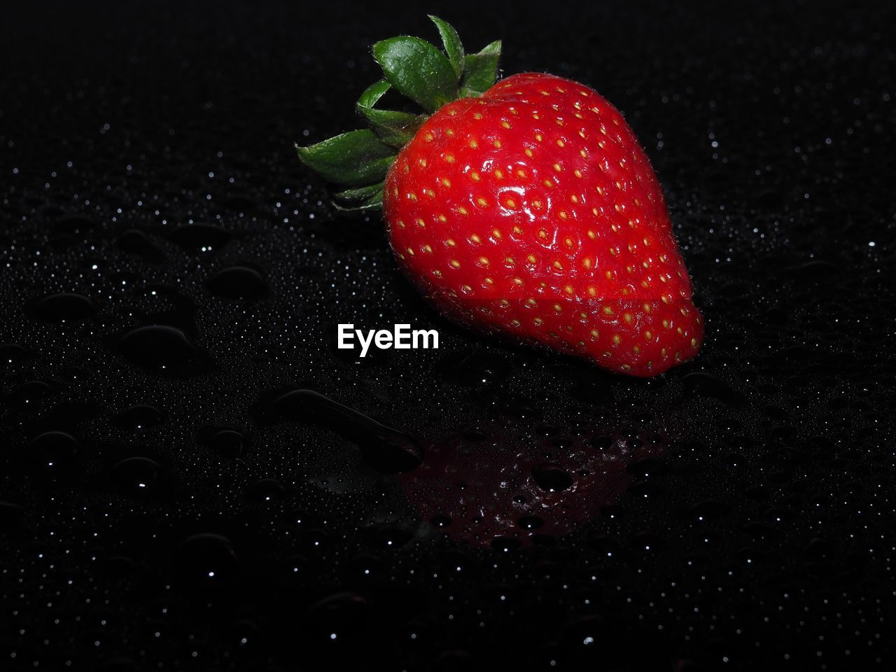 Close-up of strawberry on black surface