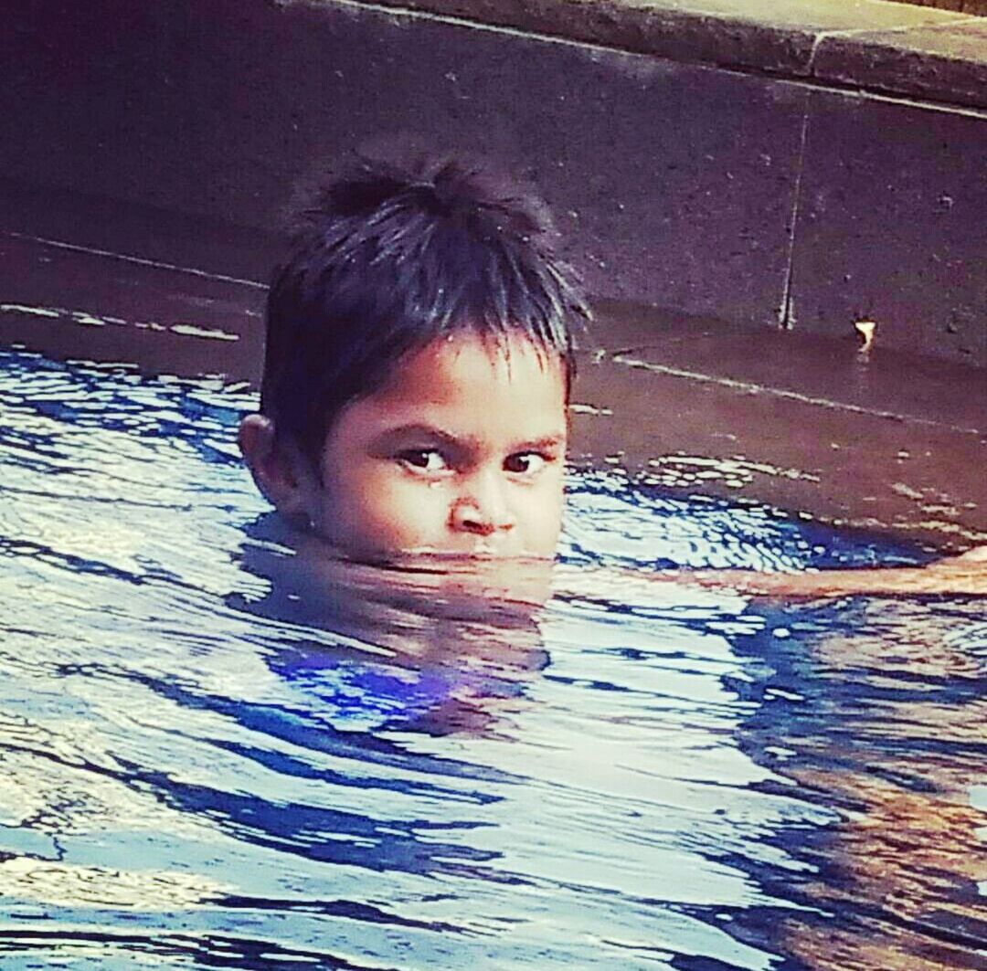 PORTRAIT OF BOY SWIMMING IN WATER