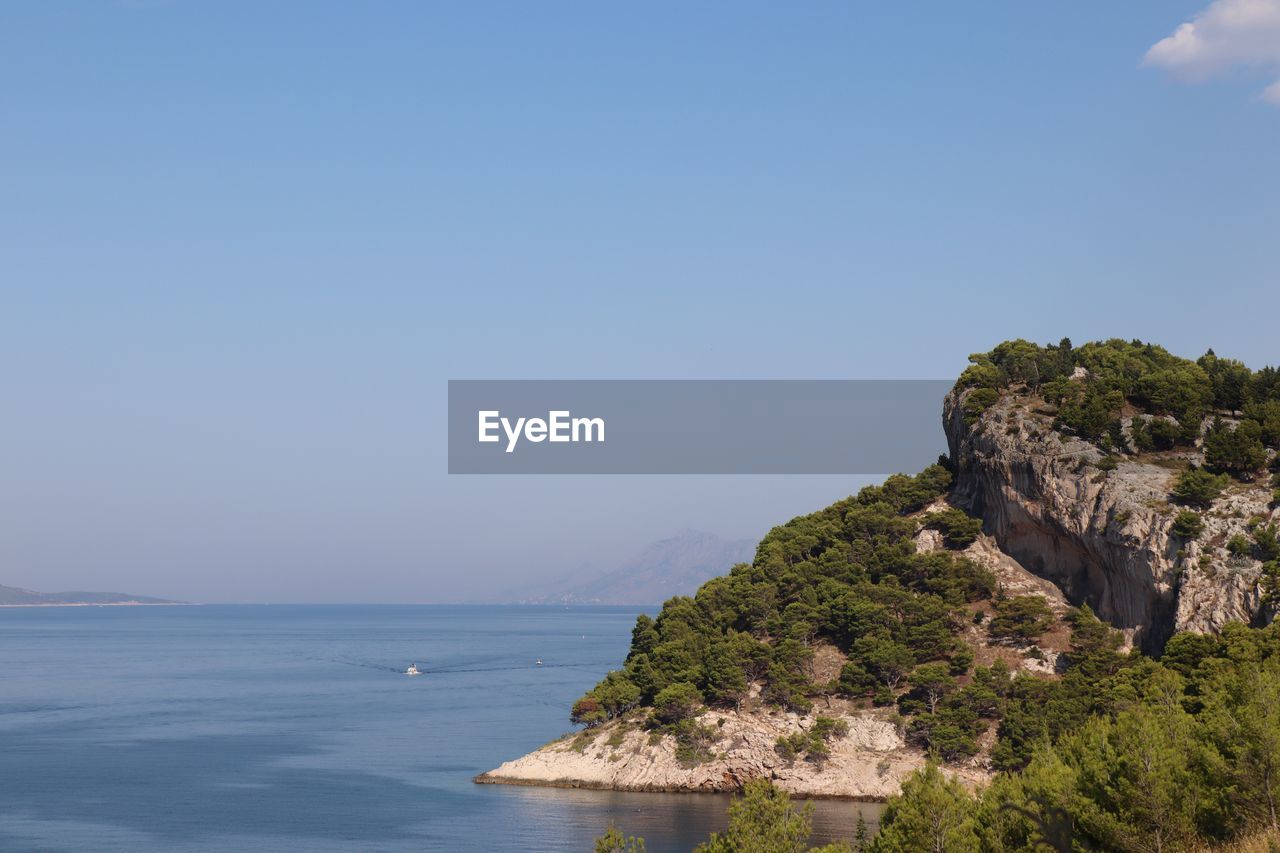 Scenic view of sea against clear blue sky