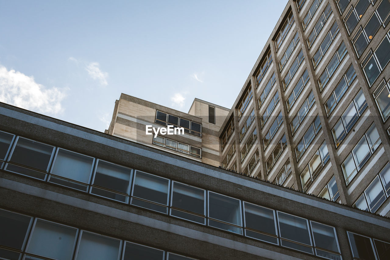Low angle view of modern building in city on sunny day