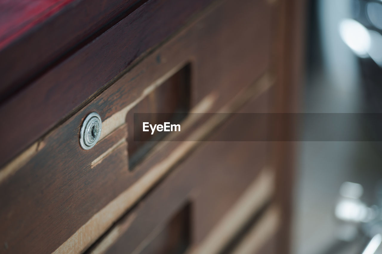 The drawer keyhole represents the old-fashioned old wooden table that has been used for ages.