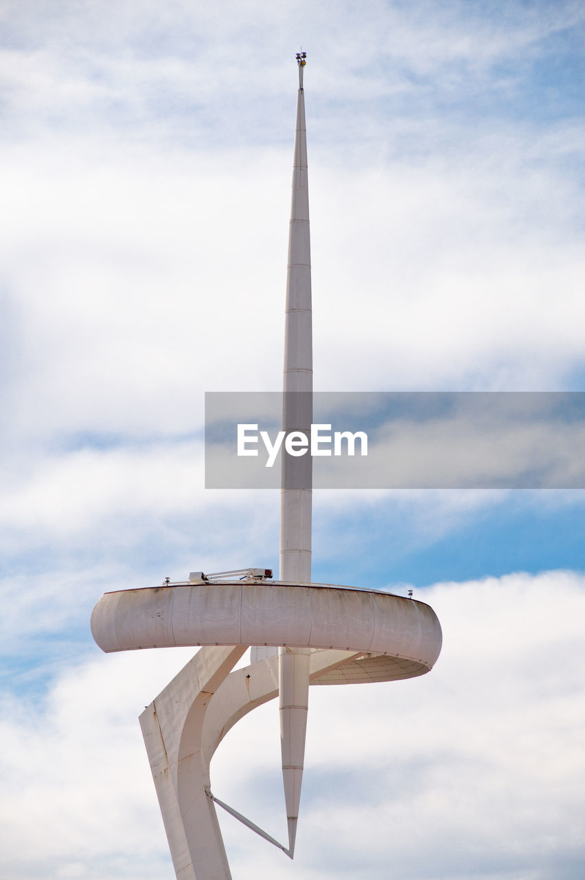 Modern tower against cloudy sky