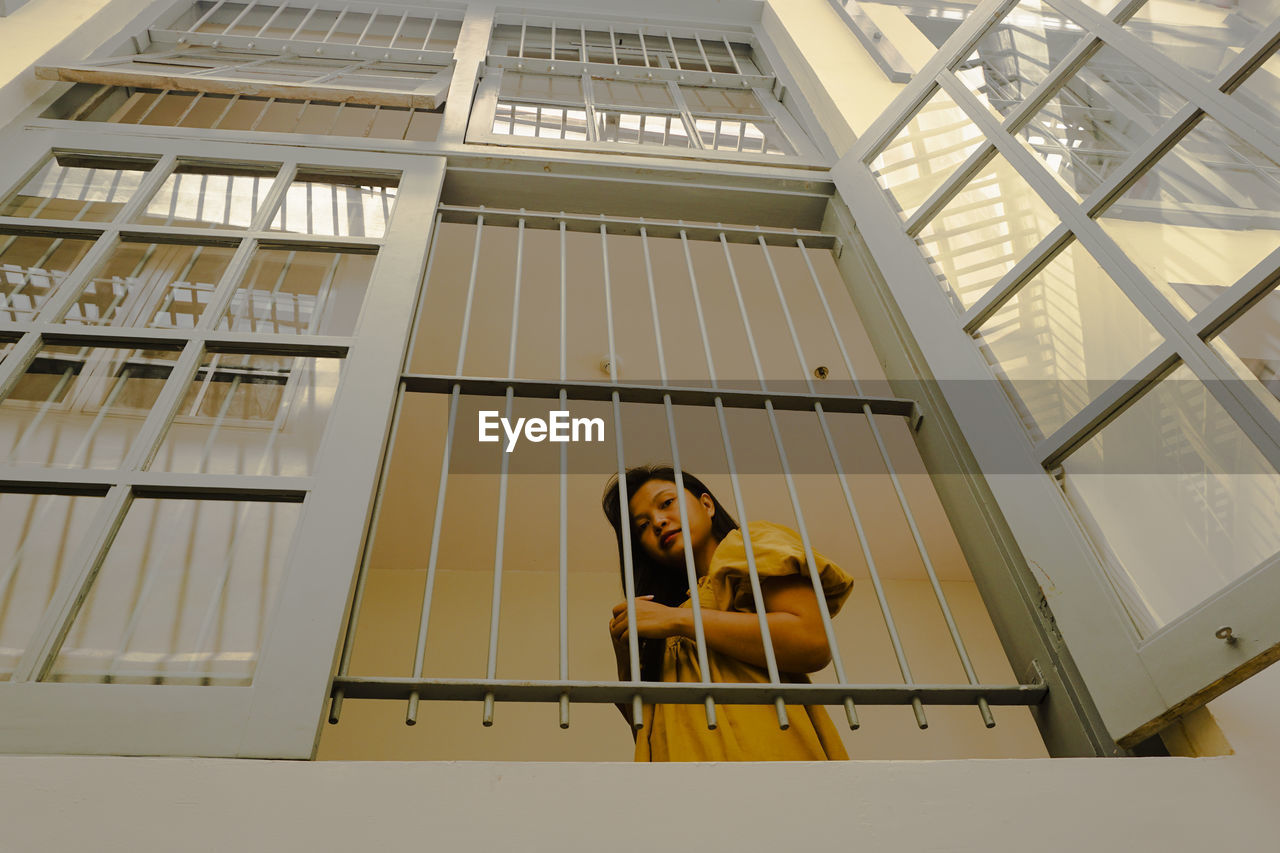 Low angle view of woman on window