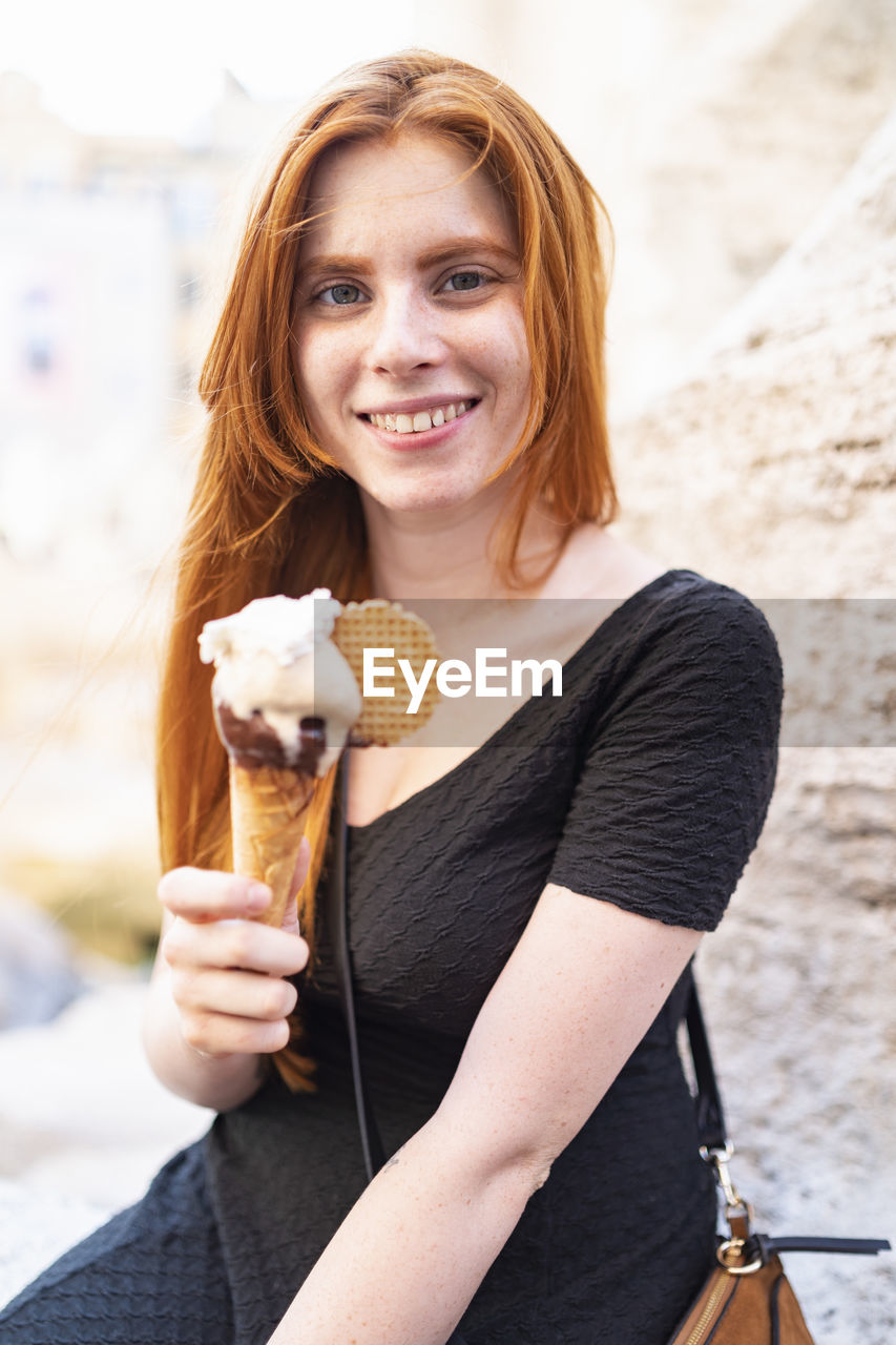 Cheerful teen female with ice cream cone