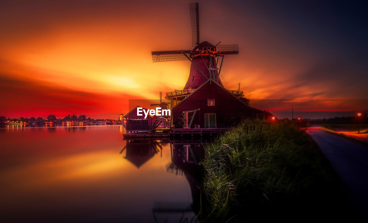 TRADITIONAL WINDMILL AGAINST ORANGE SKY