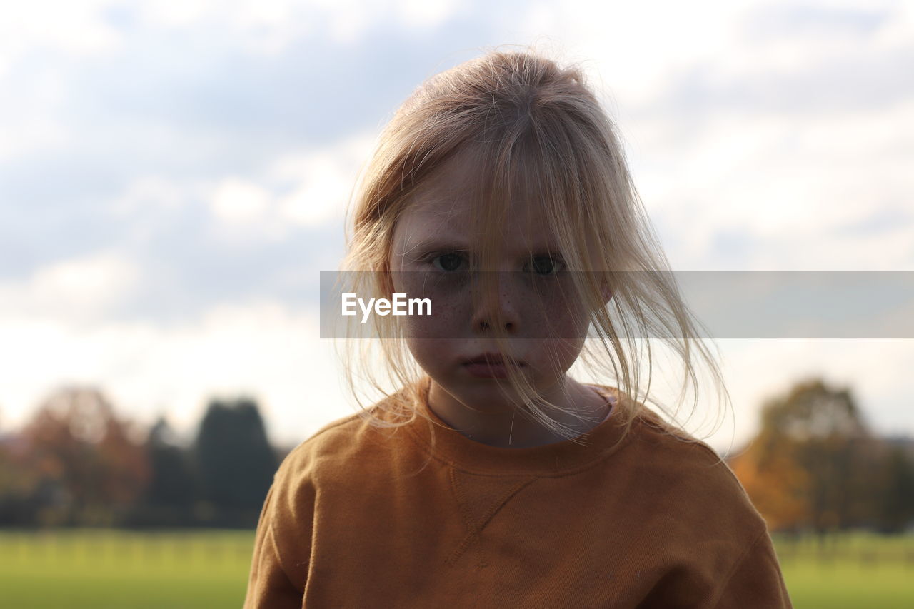 Portrait of girl against sky