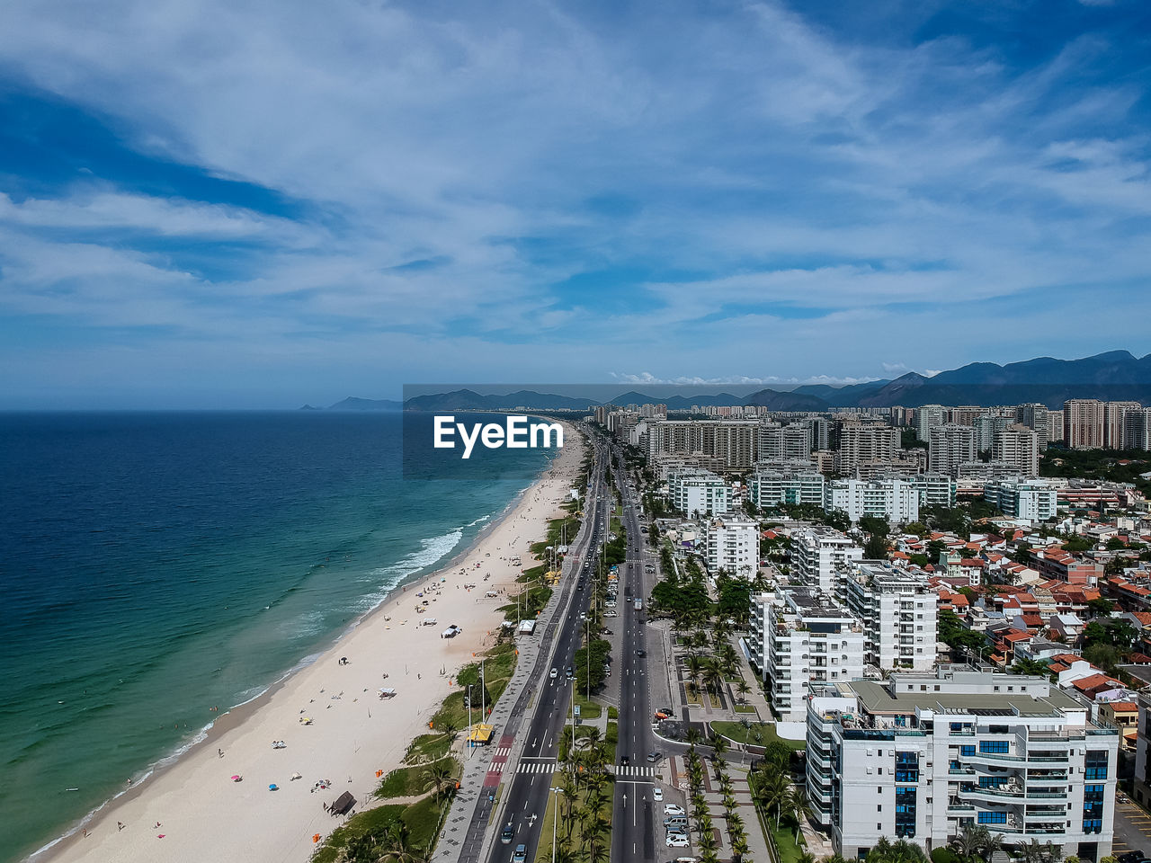 Scenic view of sea by city against sky