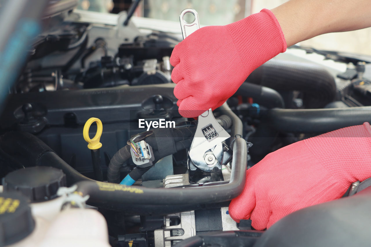 Close-up of mechanic working on car